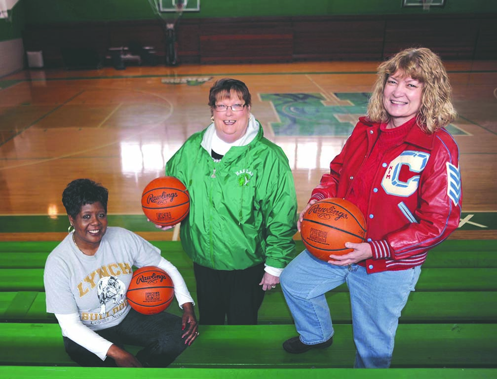 Kathy Thomas (left), Maralee Holder and Kim Kelley are pictured in the Harlan gym, where they led their respective teams in the first girls 52nd District Tournament in 1975.