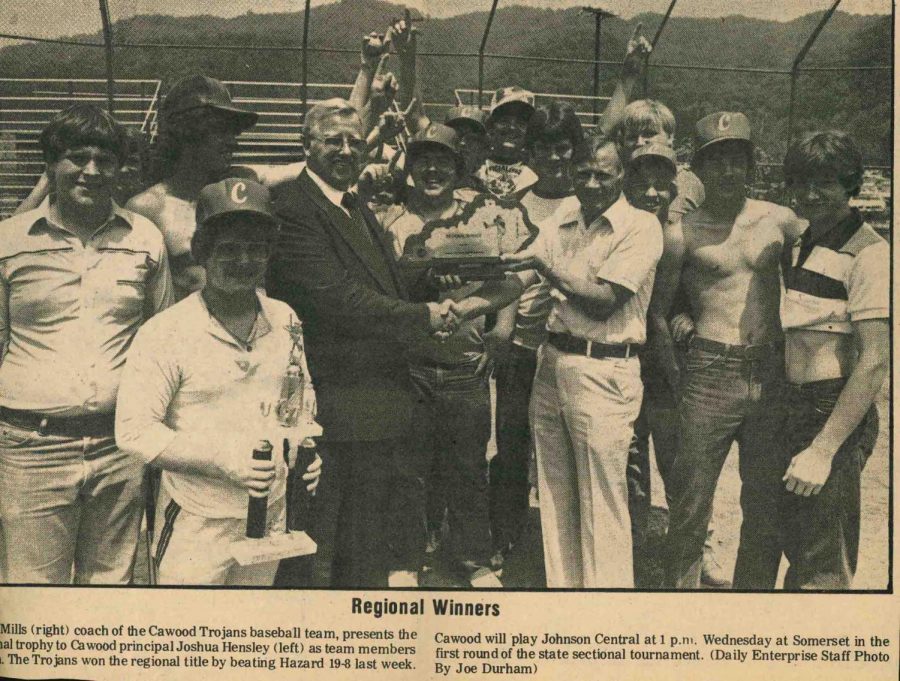 Cawood won its first and only regional baseball title in 1982, defeating Hazard in the 14th Region Tournament finals. The Trojans defeated Johnson Central in the sectional before falling a game short of the state final four with a loss to Middlesboro. Cawood High School Principal Josh Hensley is pictured presenting the championship trophy to coach Basil Mills. Other team members pictured include William Hatfield, David Hensley, Robbie Burns,  Jimmy Gross, Gregg Osborne, John Stepp, Buddy Howard Tracy Blanton, Eddie Hampton, Keith Hensley and Jack Hampton.