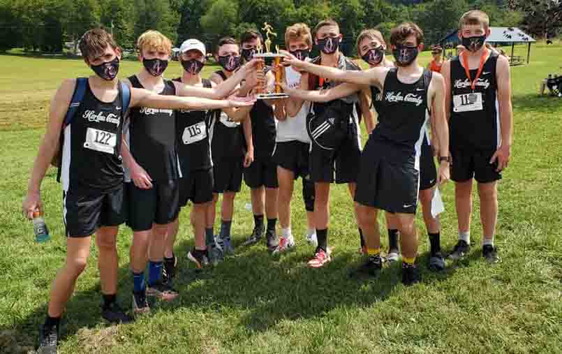 The+Harlan+County+Black+Bears+are+pictured+with+their+trophy+after+placing+second+in+the+season-opening+meet+Saturday+at+Lynn+Camp.+The+HCHS+girls+also+placed+second.
