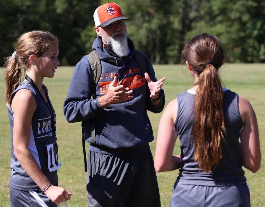 Lynn Camp cross country coach Marc Estep talked to two members of his team during the Black Bear Invitational on Saturday. Estep was a member of three regional championship cross country teams under Leo Miller at Harlan from 1985 to 1987 and was a state champion in track in the 800 meters.