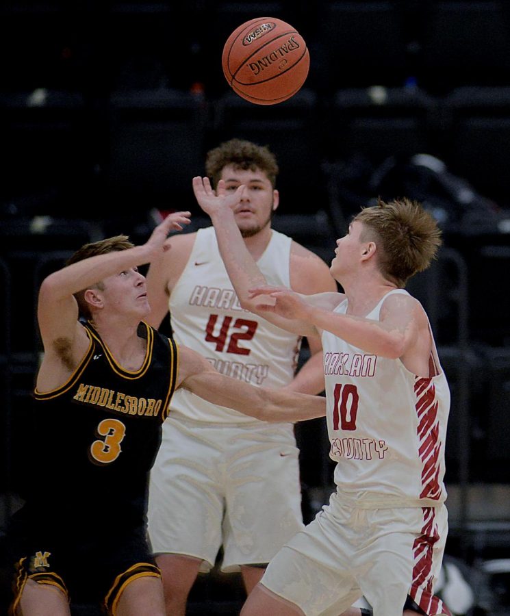 Middlesboro's Ethan Barton and Harlan County's Jonah Swanner battled for a loose ball in Friday's district clash. The Black Bears improved to 9-1 overall and 3-0 in district action with a 69-49 victory.
