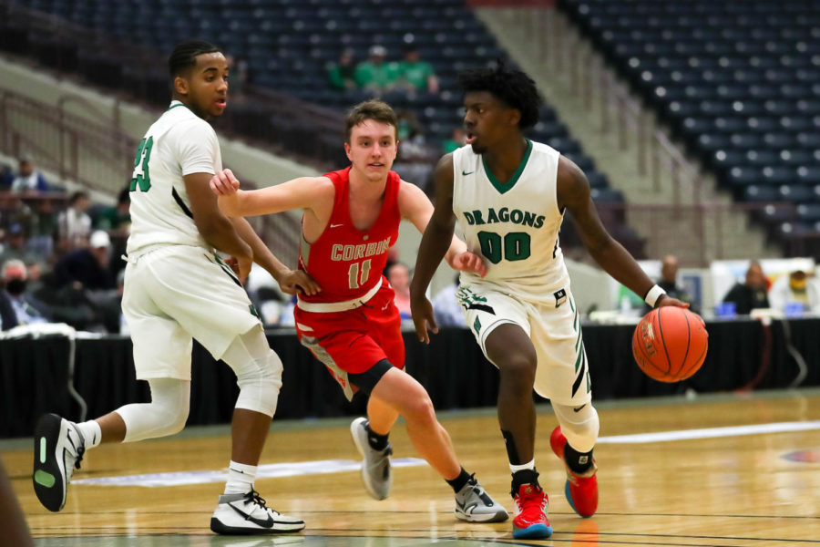 Harlans Jordan Akal worked around Corbins Josh Hibbits in 13th Region Tournament action Monday. Akal scored 25 points in the Dragons 63-53 loss.