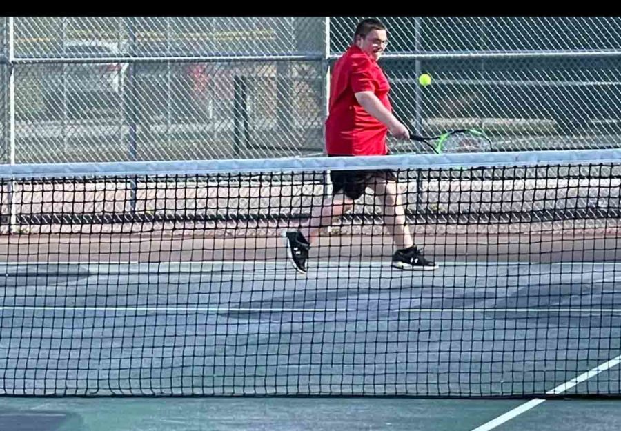 Harlan County freshman Calan Neely returned a shot in tennis action Monday at Harlan. Both HCHS teams claimed wins.