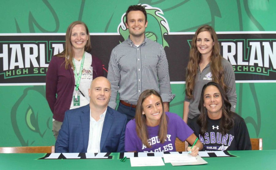 Ella+Morton+signed+with+Asbury+University+on+Monday+to+continue+her+cross+country+and+track+career.+Pictured+with+Morton+at+the+signing+ceremony+are+her+parents%2C+C.D.+and+Jennifer+Morton%2C+as+well+as+Harlan+coaches+Anne+Lindsey+and+Trevor+Fitzpatrick+and+Asbury+assistant+coach+Molly+Halpin%3B+not+pictured%3A+Harlan+assistant+coach+Mike+Pace.