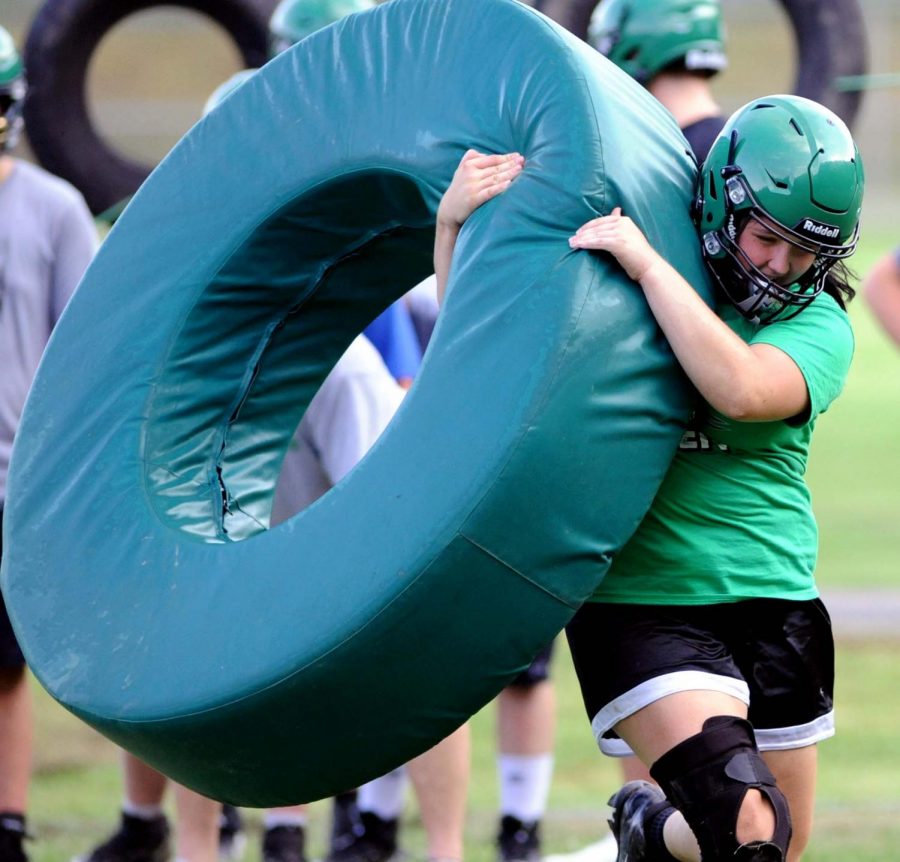 Harlan junior Hanna Pace worked through a tackling drill at a recent practice session.
