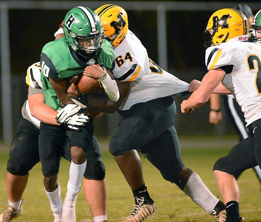 Middlesboro senior tackle Jalil Patterson-Graves and several teammates brought down Harlan quarterback Darius Akal in Fridays game. The Jackets held Harlan to 67 yards rushing in a 44-6 win.