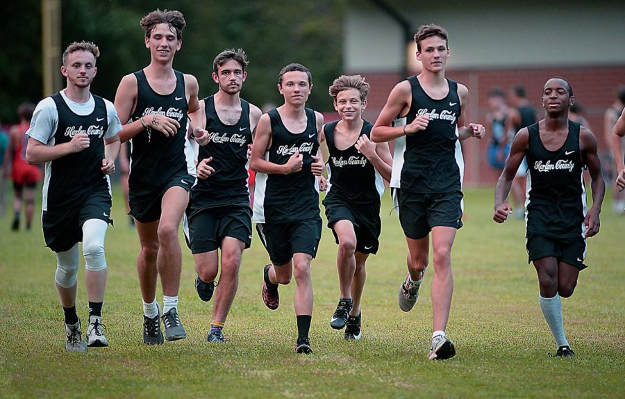 Members of the Harlan County High School boys team warmed up before a meet Tuesday.