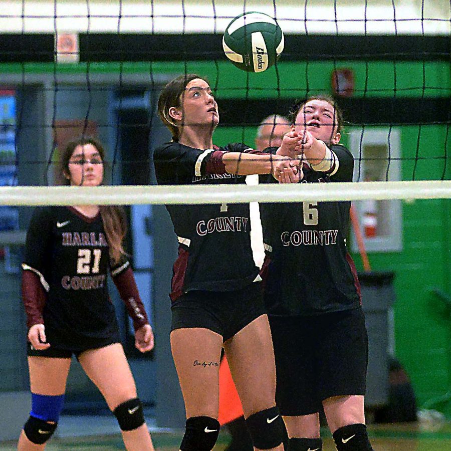 Harlan Countys Lily Caballero and Kalista Dunn went to the net to keep the ball alive in 52nd District Tournament action.
