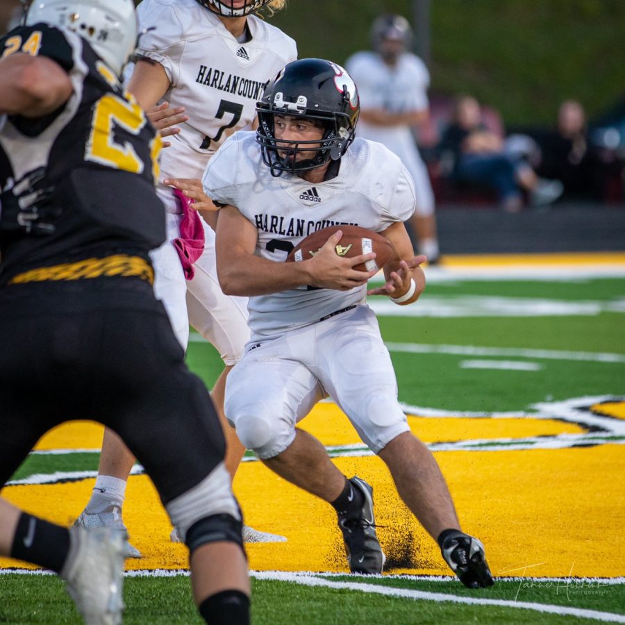 Harlan County senior running back Luke Carr took a handoff and looked for an opening in action earlier this season.