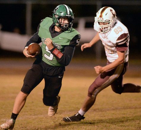 Harlan quarterback Cade Middleton broke free around a Leslie County defender in action last week. The Green Dragons fell 29-26 at Pineville on Thursday in the first round of the Class A playoffs.