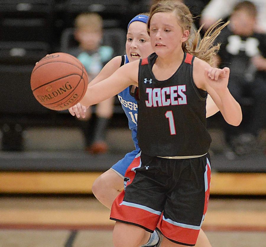 James A. Cawoods Carmen Thomas and Rosspoints Jaycee Simpson went after a loose ball in championship game action Thursday in the fifth- and sixth-grade tournament. Rosspoint won its second straight title with a 35-30 victory.