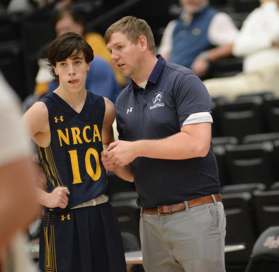 North Raleigh Christian Academy coach Ronnie Kruger talked to Parker Hodgson during Tuesdays game against Harlan County.
