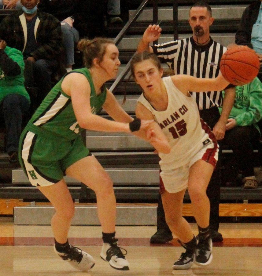 Harlan Countys Ella Karst worked around Harlan guard Faith Hoskins in district action Saturday. Karst scored 18 points in the Lady Bears 73-62 victory.
