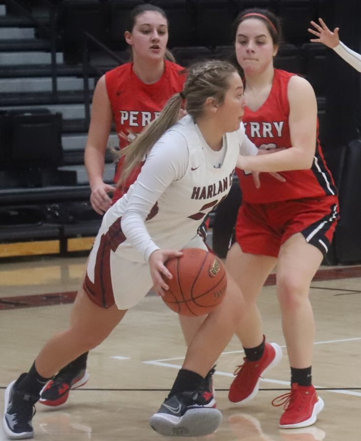 Harlan Countys Hailey Austin worked around a Perry Central defender in Mondays game. Austin scored nine points in the Lady Bears 59-55 victory.