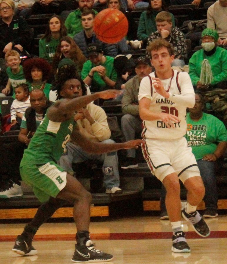Harlan Countys Jackson Huff passed the ball as Harlans Jordan Akal defended in Fridays district clash. Huff scored 15 as the Bears won 87-74.