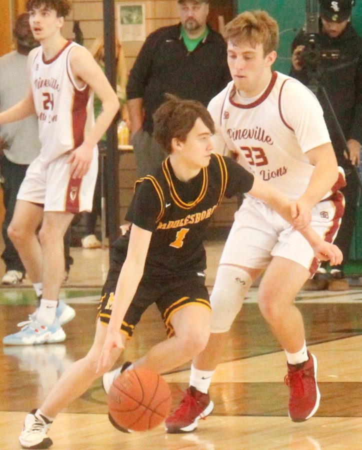 Middlesboros Brayden Barnard drove against PInevilles Evan Biliter in All A tournament action. Middlesboro advanced with a 55-49 victory.