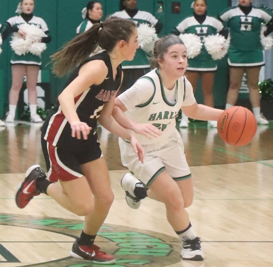 Harlan point guard Emma Owens brought the ball up the court against Harlan Countys Ella Karst in Tuesdays district clash.