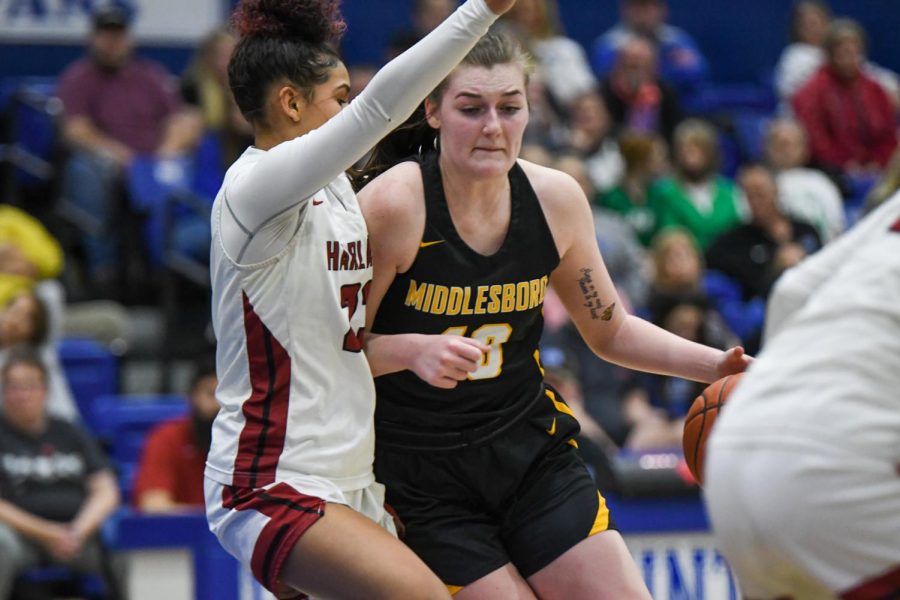 Middlesboro forward Kailey Owens went to the basket as Harlan Countys Paige Phillips defended in 52nd District Tournament action Monday.