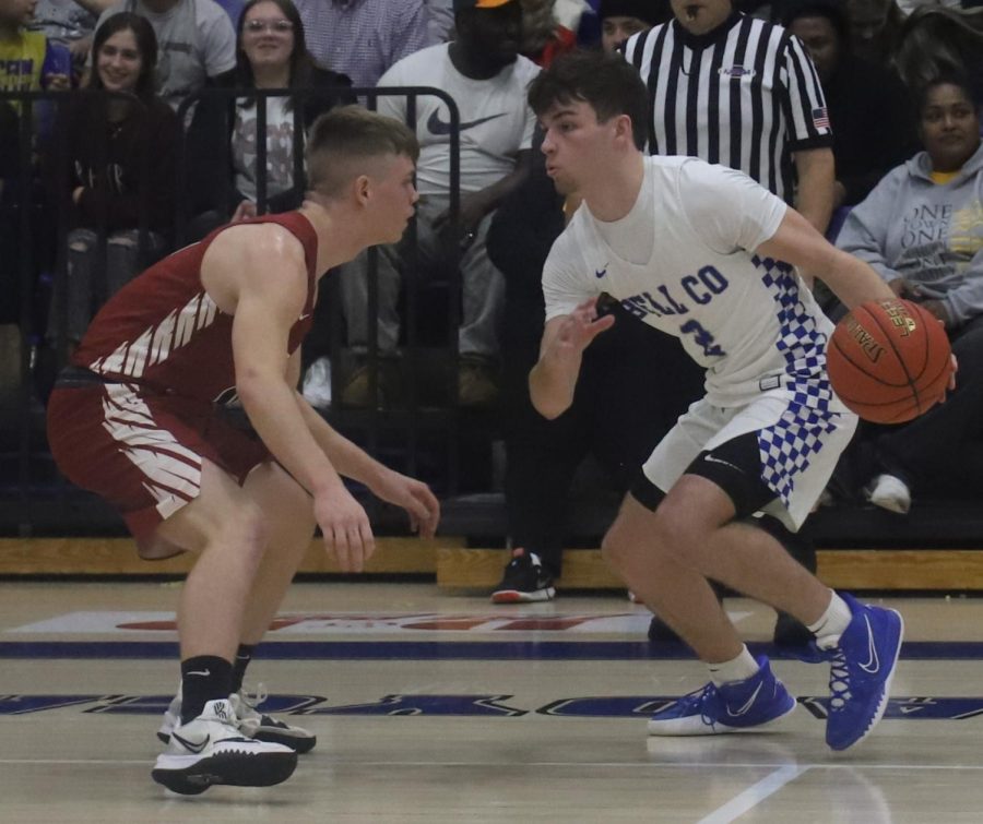 Bell County guard Dawson Woolum worked against Harlan Countys Jonah Swanner in 52nd District Tournament action Tuesday. Woolum scored 22 points and had the game-winning three-point play in overtime as Bell won 55-54.