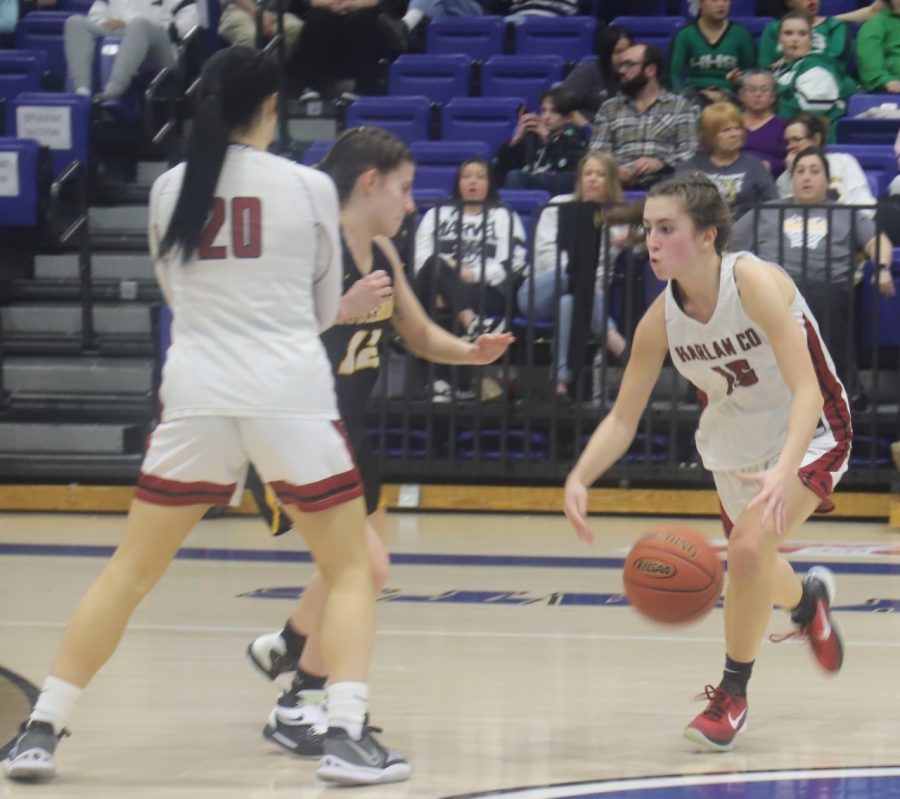 Harlan County guard Ella Karst used a pick from Jaylin Smith to break free during 52nd District Tournament action Monday. Karst scored 18 points in the Lady Bears 47-43 victory.