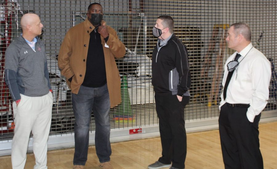Former Cumberland and Tennessee Wesleyan standout Paul Gaffney, who spent 15 years as a member of the Harlan Globetrotters, toured Harlan County High School on Tuesday. Gaffney is pictured talking with HCHS boys basketball coach Michael Jones, HCHS athletic director Eugene Farmer and HCHS girls basketball coach/assistant principal Anthony Nolan during his tour. Gaffney also talked with members of both Harlan County basketball teams. He also attended the Harlan County-Harlan games that evening at Harlan HIgh School.