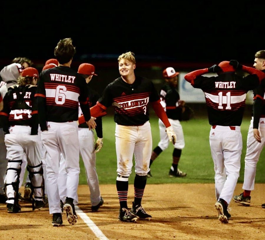 Caden Petrey’s teammates celebrated with him after he hit a walk-off two-run homer on Friday in Whitley County’s 11-1 win over visiting Harlan County.