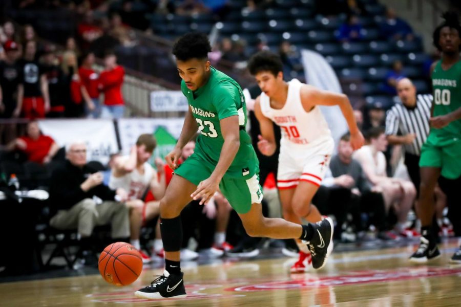 Harlan junior forward Jaeden Gist raced down the court in 13th Region Tournament action Wednesday. Gist scored 18 points in the Green Dragons 74-58 loss.