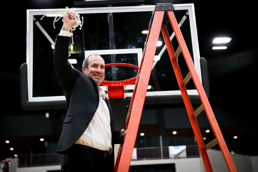 North Laurel coach Nate Valentine is pictured with the net after leading the Jaguars to the 13th Region title on Monday at The Corbin Arena.