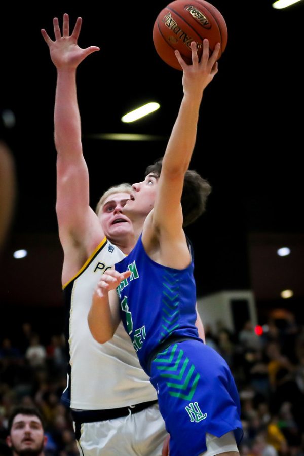North Laurel junior guard Reed Sheppard went to the basket against Knox Centrals Gavin Chadwell in action from the 13th Region Tournament championship game Monday. Sheppard scored 37 points in the Jaguars 69-56 victory.