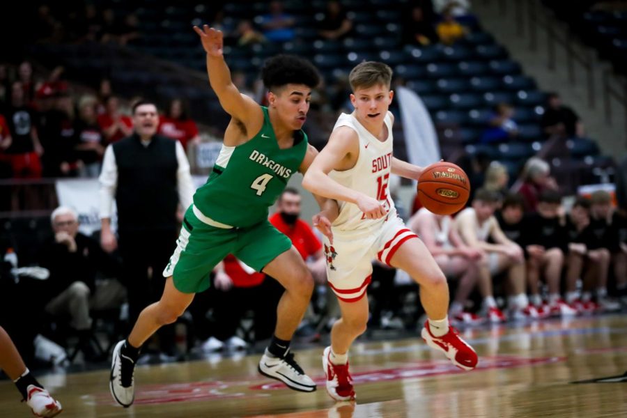 South Laurels Ashton Garland worked around Harlans Kaleb McLendon in action from the 13th Region Tournament on Wednesday. Garland scored a team-high 15 points in Souths 74-58 victory.