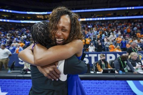 Kentucky coach Kyra Elzy (right) hugged associate head coach Niya Butts after Kentucky beat Tennessee in an NCAA college basketball semifinal round game at the womens Southeastern Conference Tournament.
