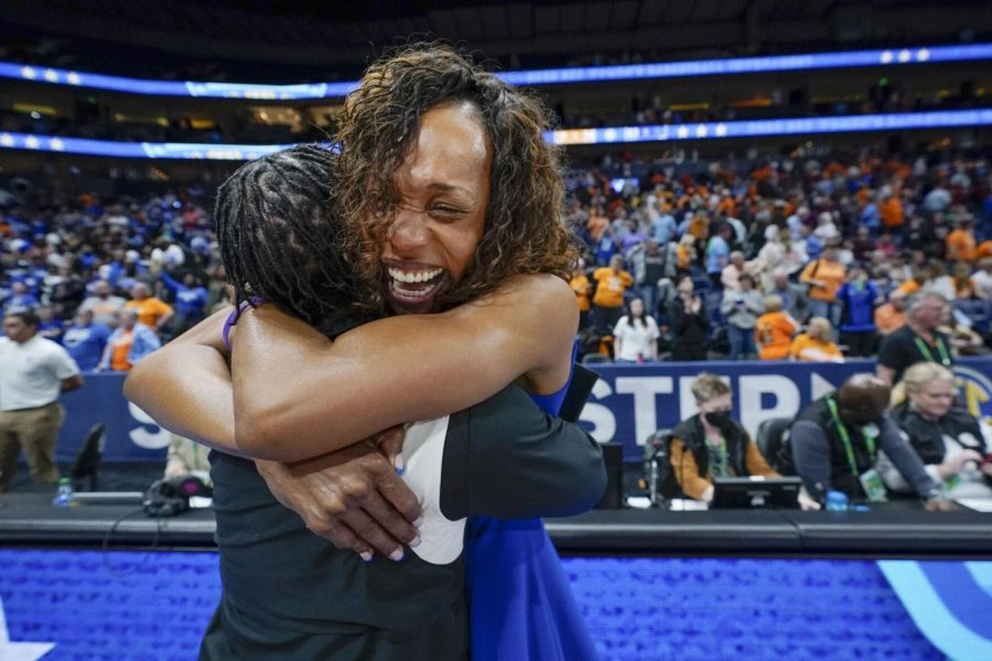 Kentucky coach Kyra Elzy (right) hugged associate head coach Niya Butts after Kentucky beat Tennessee in an NCAA college basketball semifinal round game at the women's Southeastern Conference Tournament.