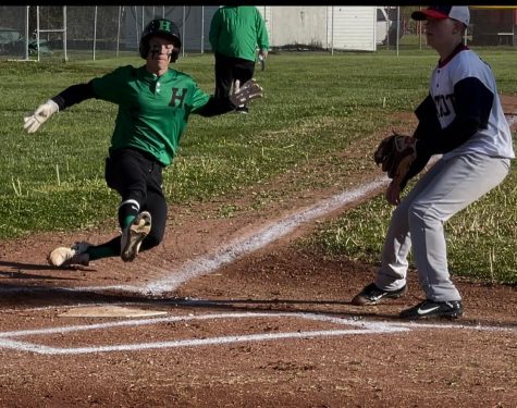Harlans Jake Brewer slid home with a run in the Dragons win at New Harlan.