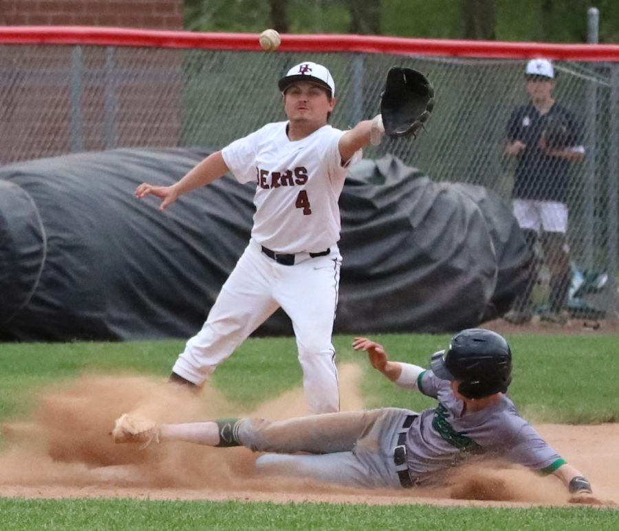 Harlans Evan Browning slid into third base ahead of the throw to Harlan Countys Shawn Carroll in Mondays game. Browning had two hits, scored two runs and stole two bases in the Dragons 7-4 victory.