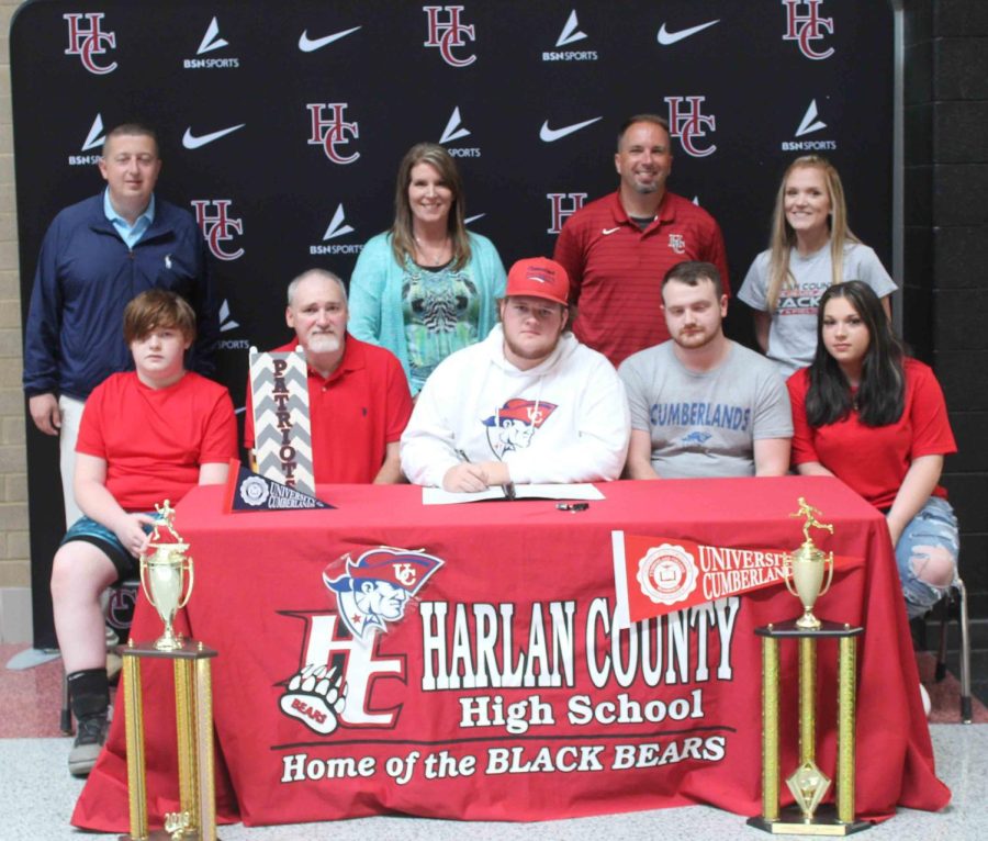 Harlan+County+High+School+senior+Ethan+Caldwell+signed+with+the+University+of+Cumberlands+on+Wednesday+to+continue+his+track+career.+Pictured+with+Caldwell+are%2C+from+left%2C+front+row%3A+Eian+Caldwell%2C+Jerry+Caldwell%2C+Trey+Farley+and+Emilee+Caldwell%3B+back+row%3A+HCHS+athletic+director+Eugene+Farmer%2C+HCHS+Principal+Kathy+Napier%2C+HCHS+track+coach+Ryan+Vitatoe+and+HCHS+assistant+coach+Arynn+Johnson.