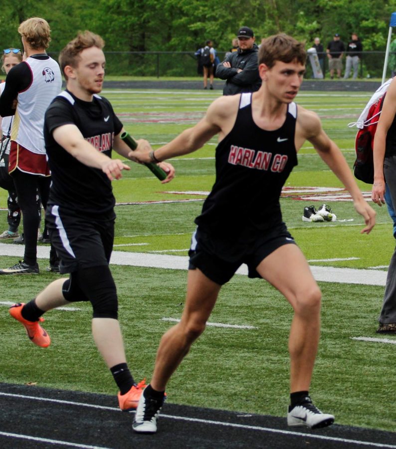 Harlan Countys Matt Yeary took the baton from Austin Crain in action from the Area 9 meet on Saturday. The Black Bears won their second straight area championship.