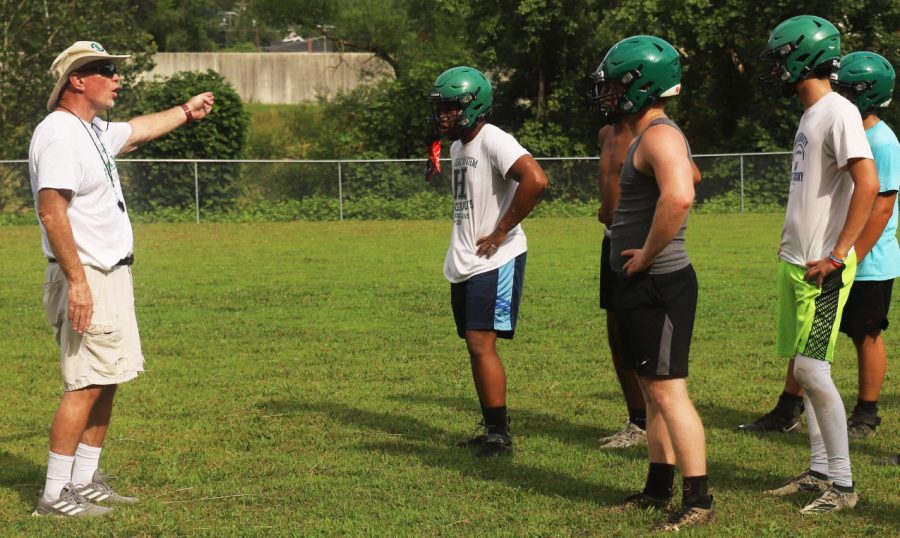 Harlan defensive coordinator Jerry Perry worked with the Green Dragons during a recent practice session.