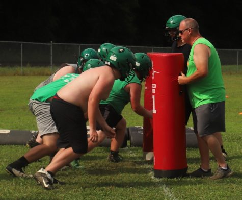 Harlan assistant coach Joe Bill Baker worked with linemen during practice on Wednesday afternoon. The Green Dragons open the regular season on Aug. 19 at home against Berea.