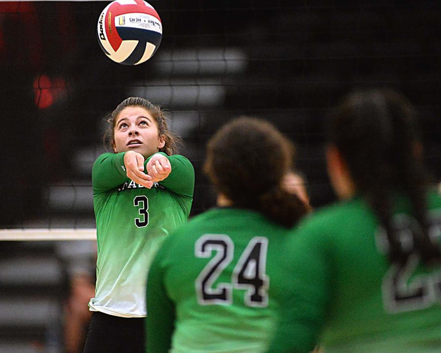 Harlan junior Emma Owens set the ball during a district clash earlier this season at Harlan County High School.