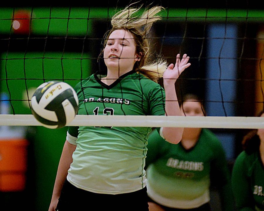 Harlan senior Marissa Marlowe went to the net to finish a point Monday in the Lady Dragons season-opening win against Middlesboro. Marlowe led the Lady Dragons with seven aces and five kills. 
