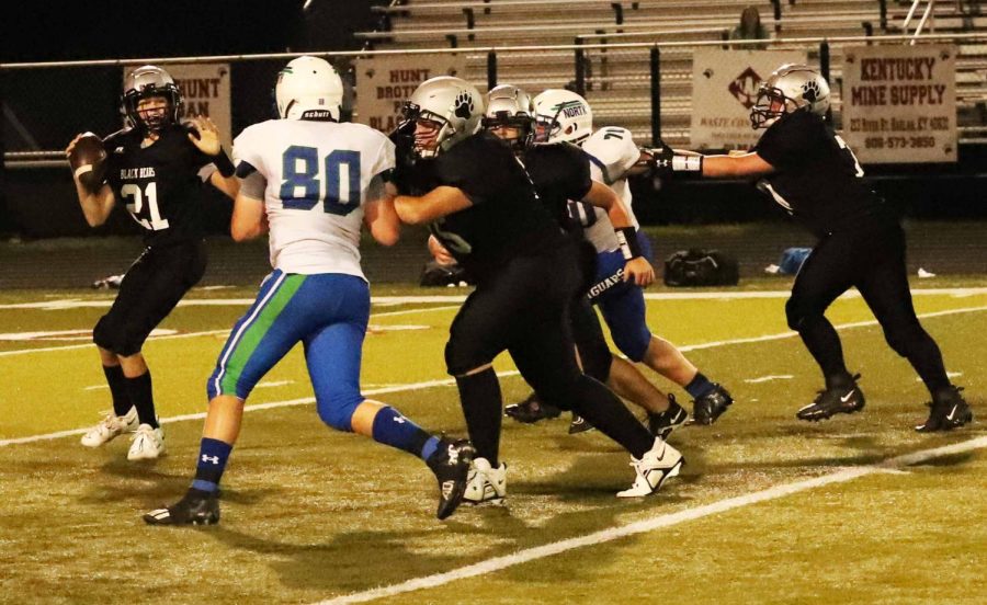 Harlan County quarterback xxx went back to pass late in the first half of Thursdays seventh-grade game against visiting North Laurel.