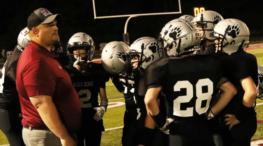 Harlan County assistant coach Jerry Cooper talked to the HC defense in the seventh-grade game Thursday at home against North Laurel.