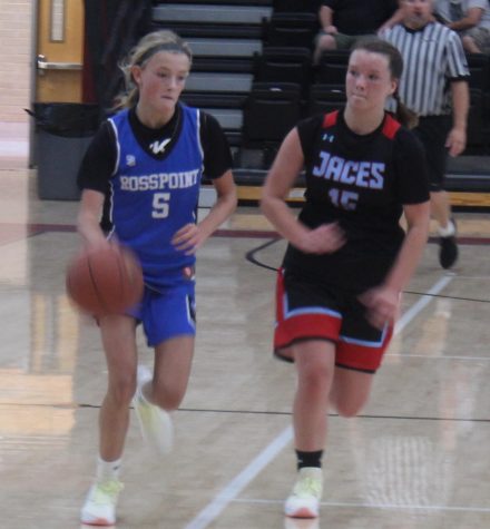 Rosspoints Lauren Lewis raced down the court as James A. Cawoods Abby Elliott gave chase in scrimmage action Saturday at Harlan County High School. Rosspoint won twice in the Harlan County Preseason Panorama.