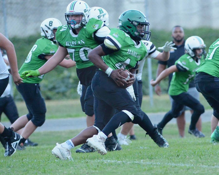 Harlan running back Boss Bryson picked up yardage in middle school football action Thursday. The visiting Jackets won 30-6.