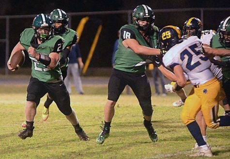 Harlans Jayden Ward headed outside as Dylan Middleton blocked in last weeks win over Sayre. The 4-1 Green Dragons travel to Phelps on Friday.