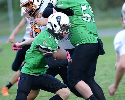 Harlan running back Jonah Sharp went behind a block from Caden Mefford in Saturdays middle school game against Williamsburg.