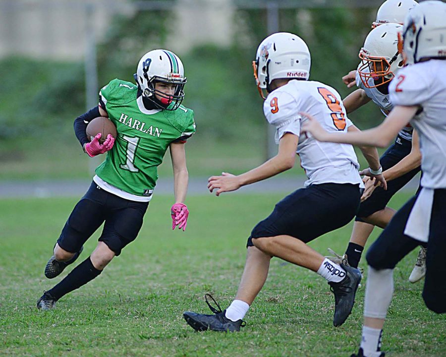 Harlans Jonah Sharp was surrounded by Williamsburg defenders in middle school football action.
