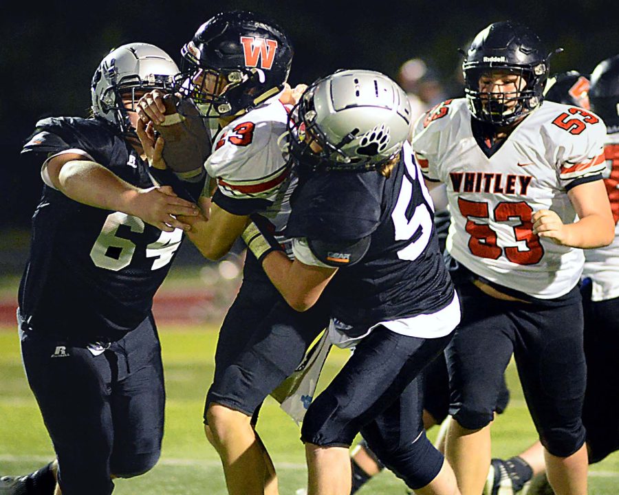 Harlan Countys Lee Senters (left) and Bo Eldridge brought down the Whitley County quarterback in Thursdays game.