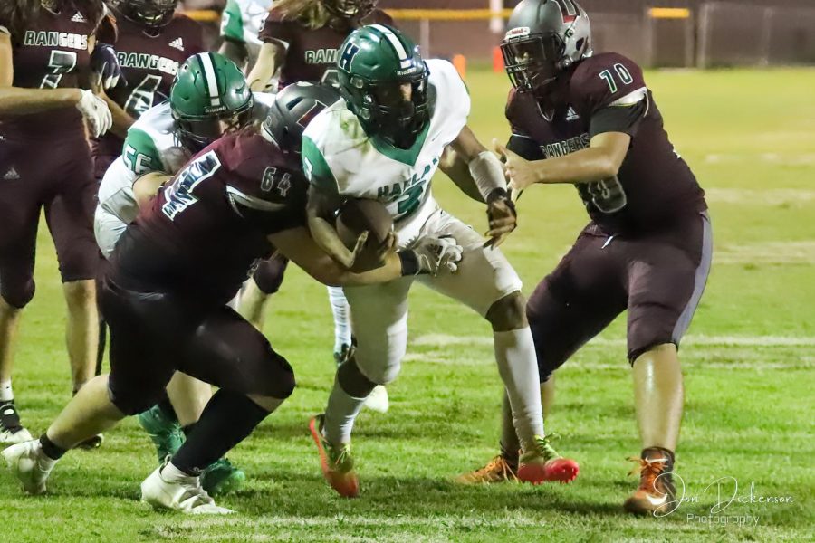 Harlan quarterback Donovan Montanaro worked his way into the end zone for one of his three touchdowns Friday in the Green Dragons 36-0 rout of Unaka, Tenn.