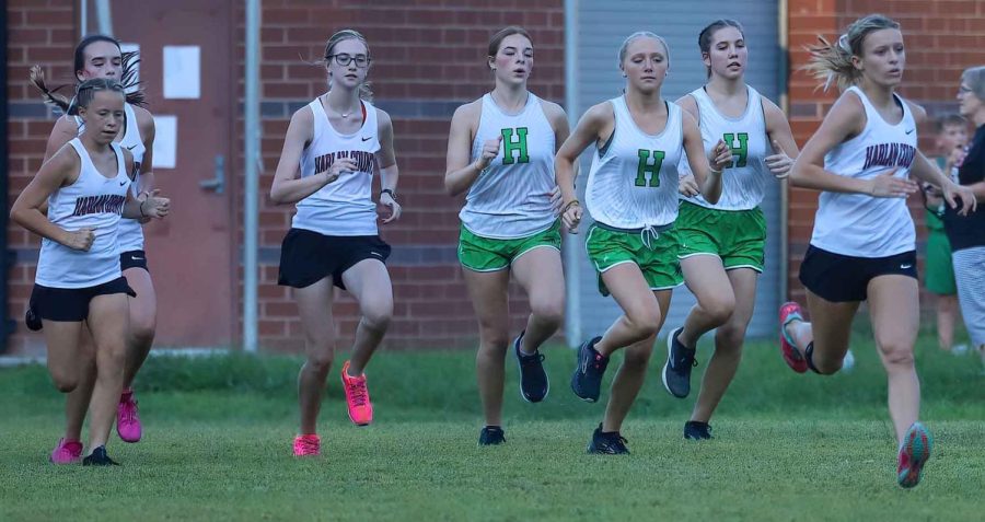 Harlan+County+and+Harlan+runners+left+the+starting+line+Tuesday+in+a+meet+at+Harlan+County+High+School.+HCHS+sophomore+Peyton+Lunsford+%28right%29+was+the+winner.